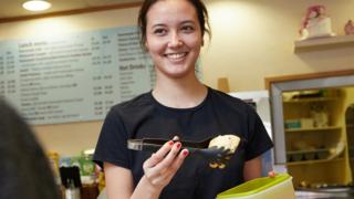 Woman putting food in tupperware