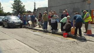 People queue to collect water in County Louth