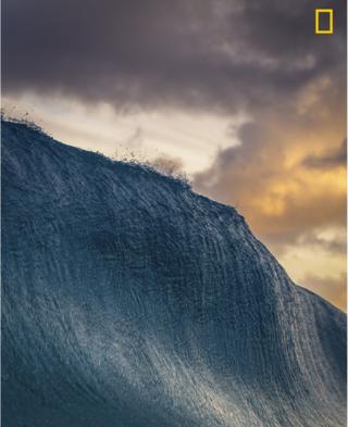 A large wave is seen before it breaks