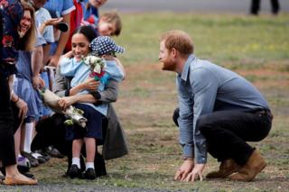 Prince Harry and Meghan, Duchess of Sussex, with a child at Dubbo Airport, Dubbo, Australia, October 17, 2018