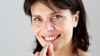 woman taking a tablet