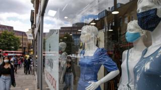 Masks on mannequins in a shop front in London