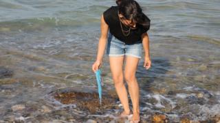 Stella Cervello gathering plastic