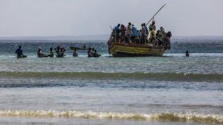 Resident fleeing violence by boat in northern Mozambique