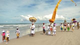 Hinduistas de Bali en la playa para la ceremonia de purificación conocida como "Melasti".