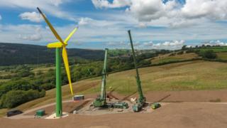 Yellow and green wind turbine in hills near Llantrisant, South Wales
