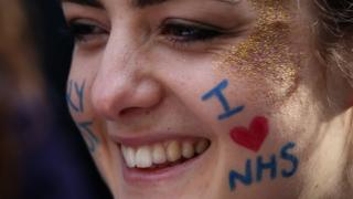 Woman with I love NHS written on her face