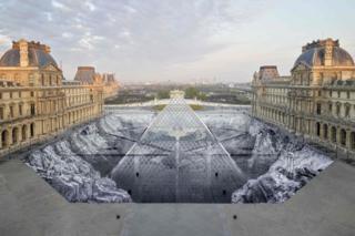 A collage by French artist JR in the courtyard of the Louvre, Paris, 30 March 2019.