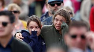 Two girls crying in the crowd at the remembrance service for victims of the mosque attacks