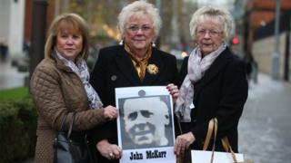 John McKerr's three daughters Agnes, Anne and Mo holding a photograph of their father