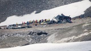Accident investigators and rescue personnel work at the wreckage of a Junkers JU52 aircraft in Flims in eastern Switzerland on 5 August 2018.