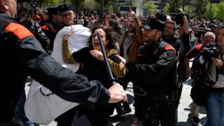 A protester breaks through a police line after a nine-year sentence was given to five men accused of the multiple rape of a woman