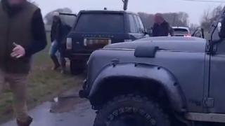 Three men getting out of off-road vehicles