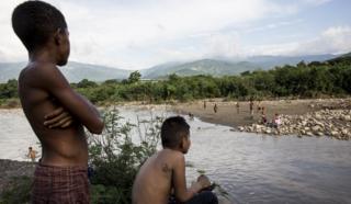 Children play in the river at the border of Columbia and Venezuela