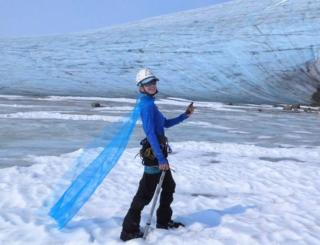 Celeste Labedz wearing a cape in front of a glacier
