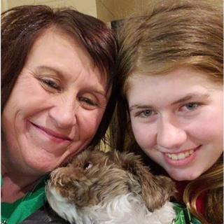 Jayme Closs (R), her aunt/godmother Jennifer Naiberg Smith (L) and Molly the dog posing together after being reunited on January 11