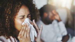 Woman sneezing