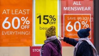 Shoppers outside a Debenhams store