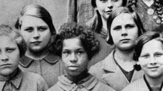 A slide used on lectures on genetics at the State Academy for Race and Health in Dresden, Germany, 1936. Original caption: "Mulatte child of a German woman and a Negro of the French Rhineland garrison troops, among her German classmates