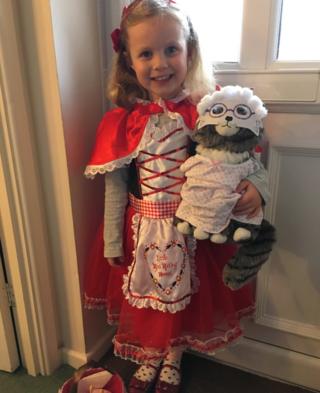 Here's Eva from Somerset, England, dressed as Little Red Riding Hood with Mog the wolf disguised as Grandma!