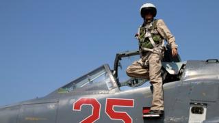 Russian army pilot poses at a cockpit of SU-25M jet fighter at Hmeimim airbase in Syria on 3 October 2015