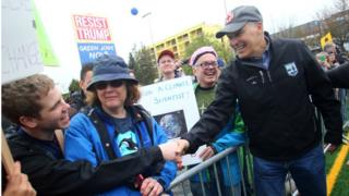 O regulador Jay Inslee do estado de Washington agita as mÃ£os com os povos na multidÃ£o apÃ³s ter falado em uma reuniÃ£o durante o marÃ§o para a ciÃªncia em Cal Anderson Park o 22 de abril de 2017 em Seattle, Washington.