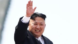 North Korean leader Kim Jong-Un waves to people attending a military parade marking the 105th birth anniversary of country's founding father, Kim Il Sung in Pyongyang, on 15 April