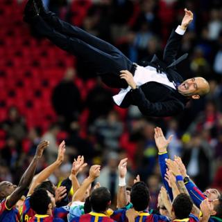 Barcelona team throws coach Pep Guardiola in the air