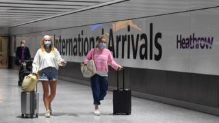 Passengers wearing face masks as they arrive at Heathrow Airport after a flight from Dubrovnik, Croatia, landed.