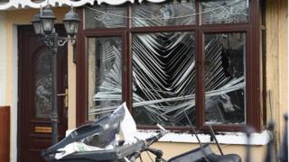 Damage to the front window of the house at Etna Drive