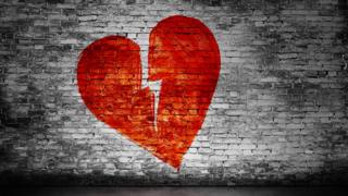 Corazón partido pintado en una pared.