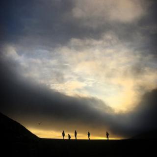 People walking at sunset