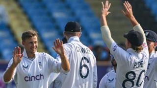 England players high five to celebrate taking a wicket