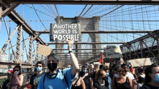 Protesters cross the Brooklyn Bridge to protest police brutality