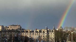 A rainbow over dark skies