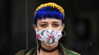 A shopper wears a face mask in the city centre of Sheffield, south Yorkshire - 24 July 2020