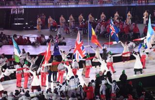 Flag bearers walk through the stadium at the closing ceremony