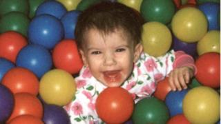 A photograph shows Baylee in a ball pool