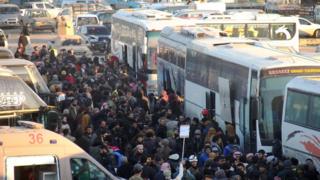 Syrians evacuated from rebel-held Aleppo arrive in Khan al-Assal on 19 December 2016
