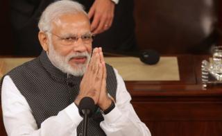 Indian Prime Minister Narendra Modi salutes while addressing a joint meeting of the U.S. Congress in the House Chamber of the U.S. Capitol June 8, 2016 in Washington, DC.