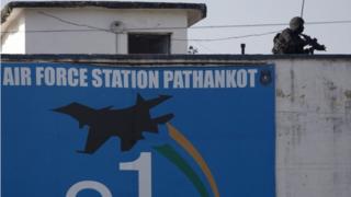 An Indian military commando is seen on the top of a building at the Indian air force base in Pathankot, India, Tuesday, Jan.5, 2016