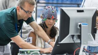 Woman wearing a brainwave-detecting cap