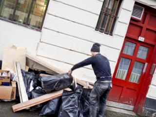 Builder putting rubbish on the street