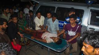 An injured Bangladeshi man is carried on a stretcher at Chittagong hospital in Chittagong on April 4, 2016, after a protest at Banshkhali turned violent