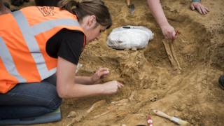A human bone is excavated in a dig at the Mont-Saint-Jean field hospital.