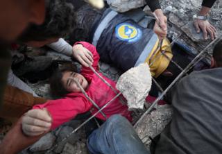 Girl being pulled out of rubble