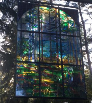Stain-glass window artwork in a forest