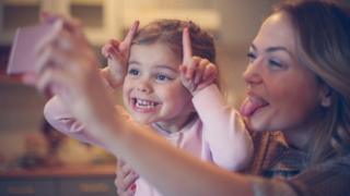 Mother and daughter take a picture (Stock photo)