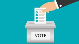 A paper being put into a ballot box