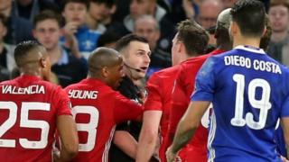 Referee Michael Oliver was surrounded by several Manchester United players after sending off midfielder Ander Herrera